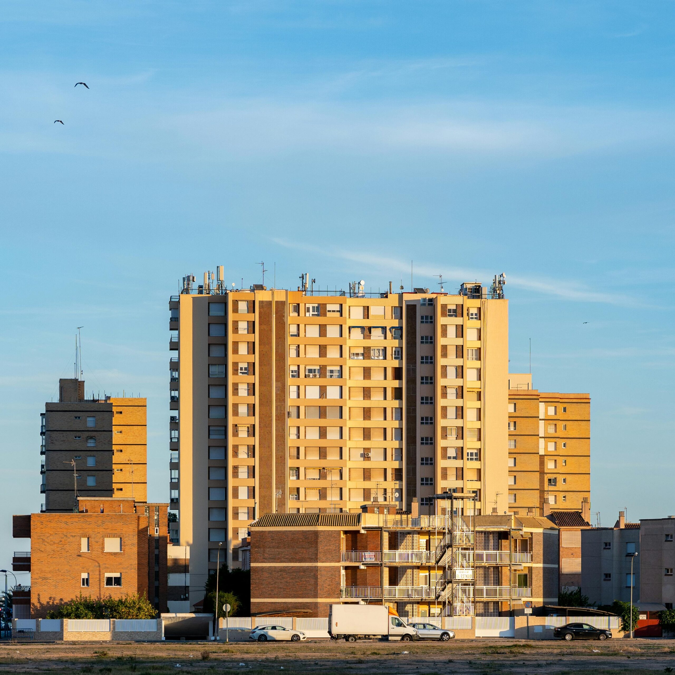 Sunlit modern apartment buildings in Santiago de la Ribera, Spain showcasing urban architecture.
