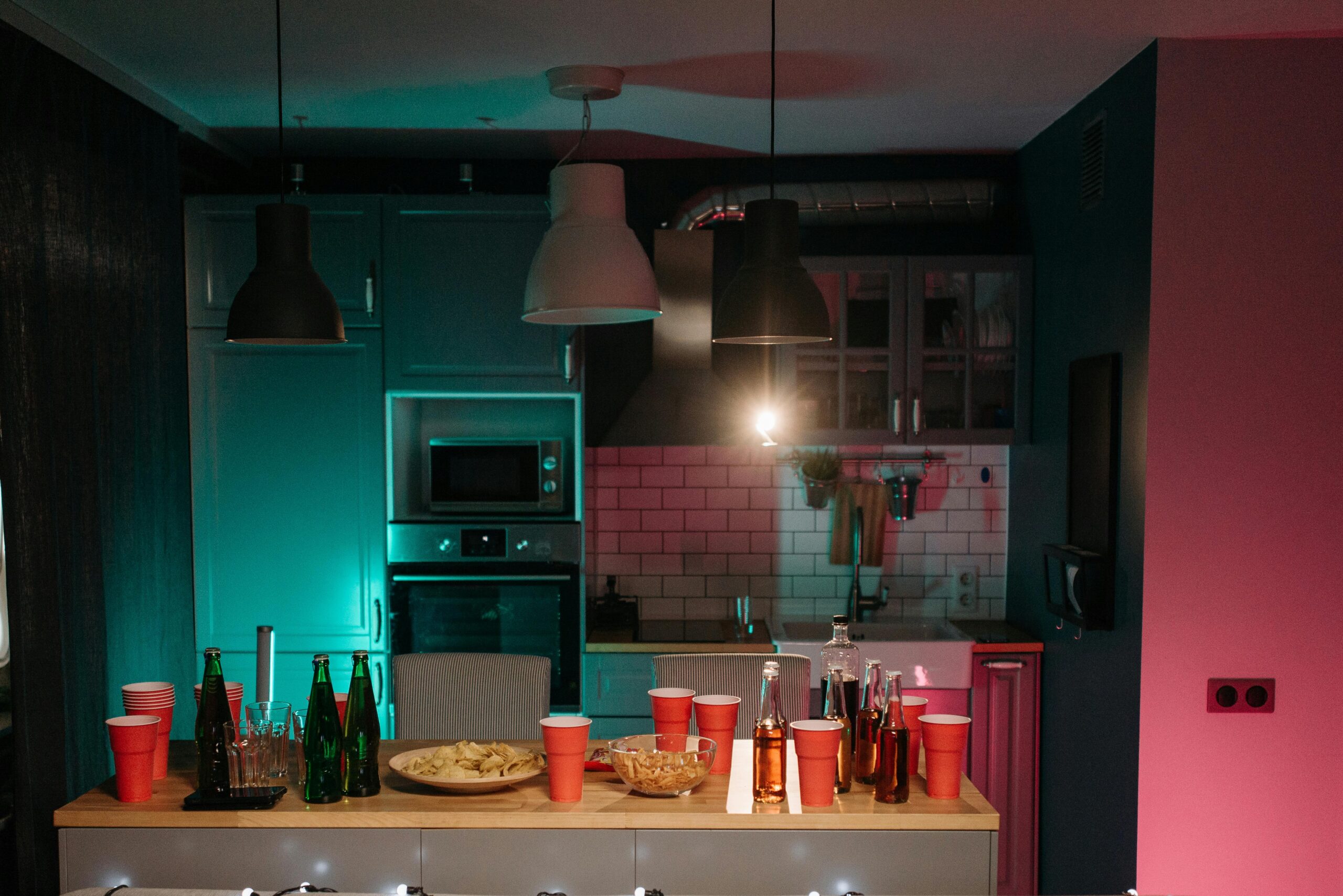 A vibrant kitchen setup with drinks and snacks ready for a party, showcasing a modern interior.